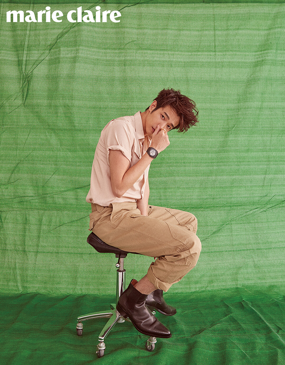 黑色鏤空 Octo 系列腕錶、18K玫瑰金與白色陶瓷 B.zero1 戒指，both by Bulgari；粉色襯衫、卡其色休閒長褲、黑色皮靴，all by Givenchy。