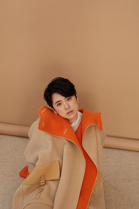 白高領透膚上衣 LOEWE；雙色駱駝斗篷大衣、米色馬褲、小牛皮長靴All by HERM&Egrave;S；幾何金耳扣、圓圈線條耳扣、圈形金耳環、字母線條戒指、金色戒指All by APM MONACO。