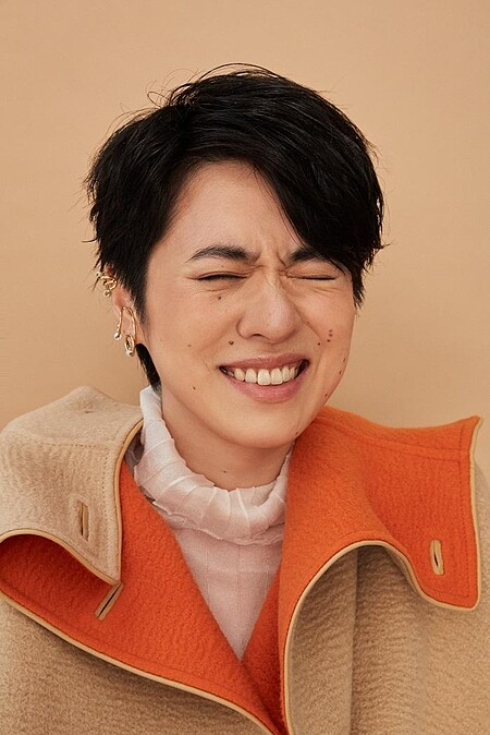 白高領透膚上衣 LOEWE；雙色駱駝斗篷大衣、米色馬褲、小牛皮長靴All by HERM&Egrave;S；幾何金耳扣、圓圈線條耳扣、圈形金耳環、字母線條戒指、金色戒指All by APM MONACO。