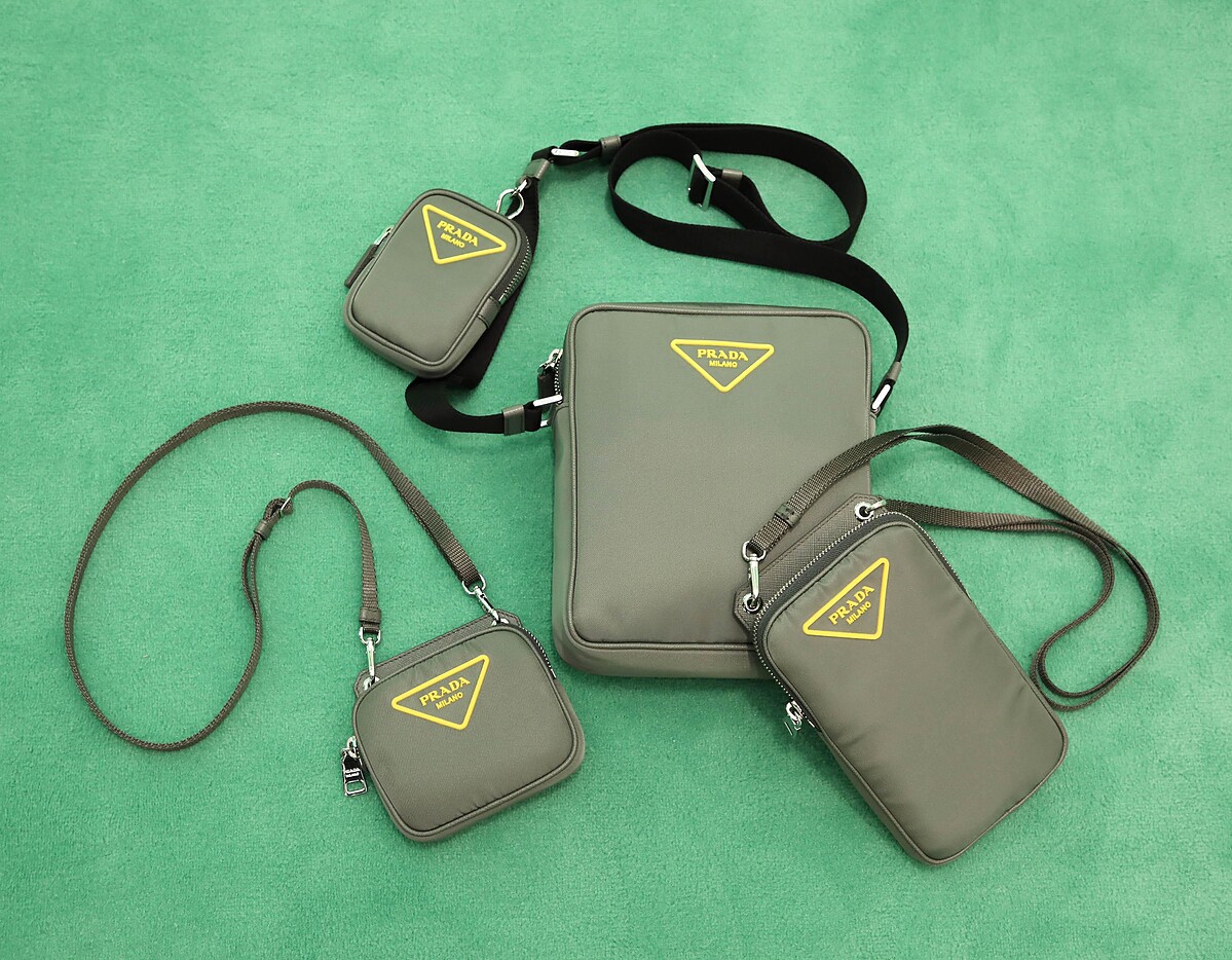 快閃店獨家：Prada黃色三角Logo灰色尼龍多功能掛頸包（NT$17,000）、 Prada黃色三角Logo尼龍信差包（NT$37,000）、Prada黃色三角Logo灰色尼龍手機包（NT$20,000） 