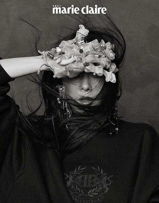 Logo 圖紋刺繡運動衫、大型蝴蝶結造型水晶耳環，both by Balenciaga。