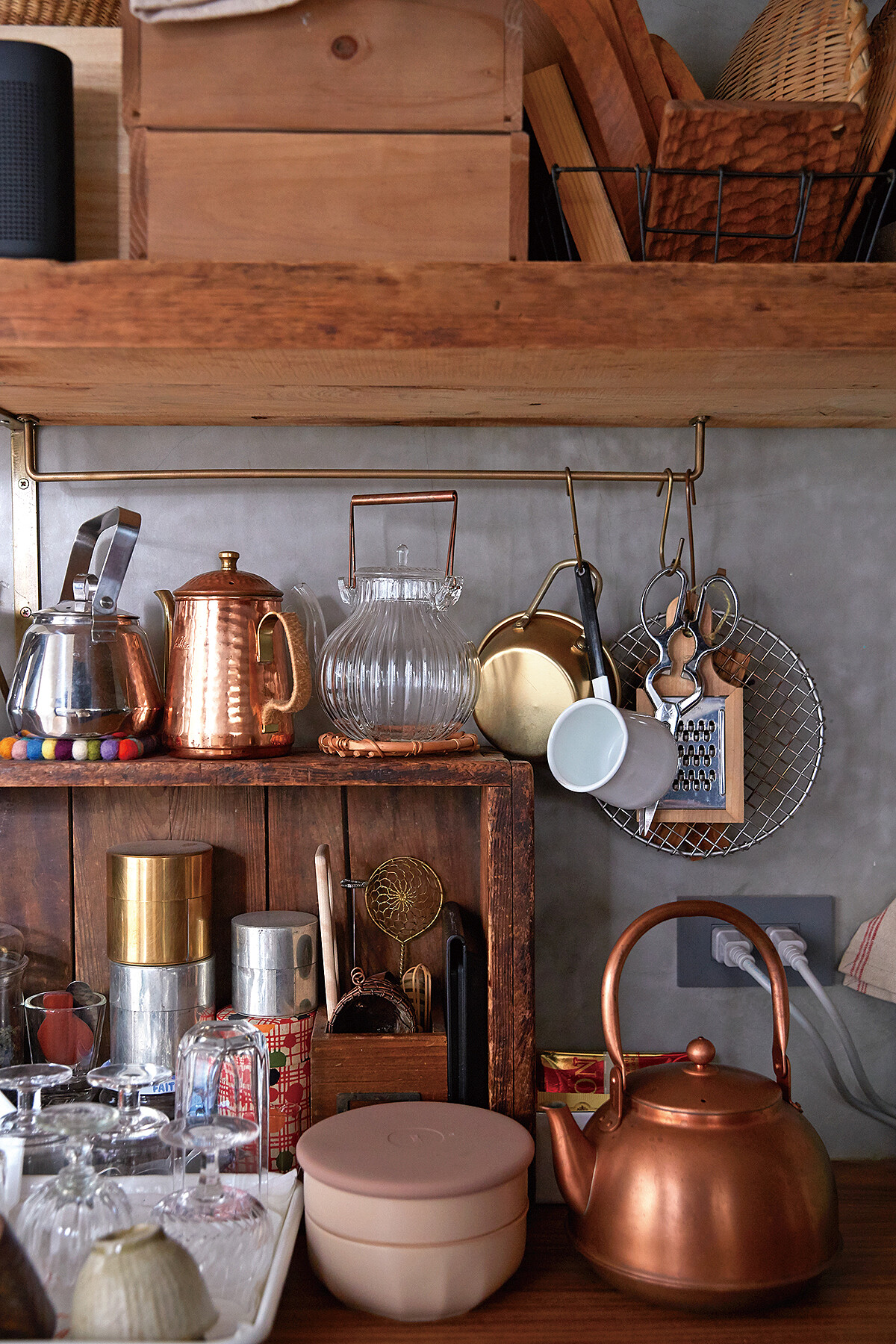 爐台背後是開放式的木頭陳列架，把喜歡的鍋具擺出來，器具顏色也規劃過，木質、玻璃、銅色，看起來不雜亂又有風格。