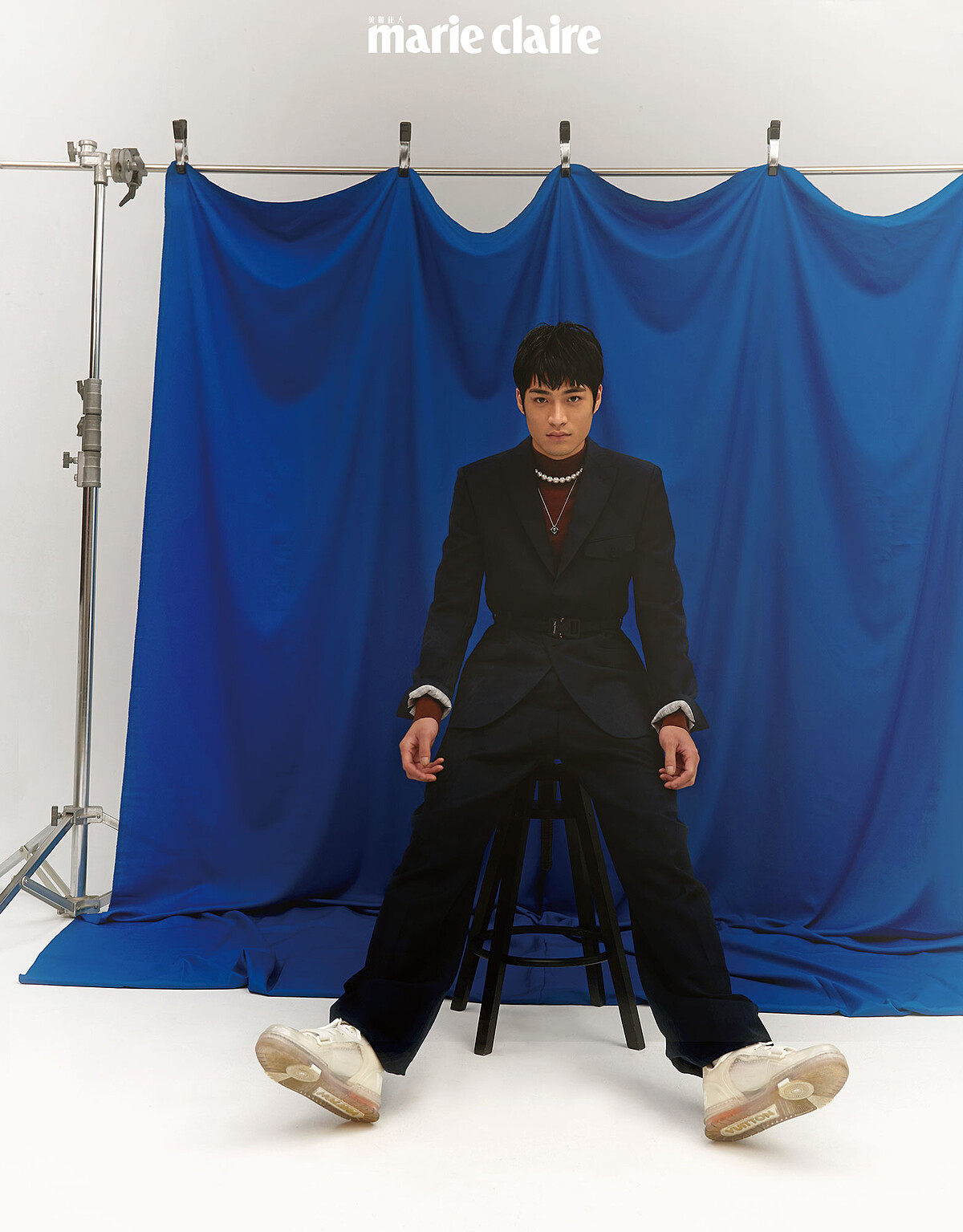 黑色西裝外套、黑色西裝寬鬆長褲，both by Dior；酒紅色高領針織衫，Sandro；南洋珍珠串鍊、黑珍珠墜鍊，both by Mikimoto，白色透明球鞋，Louis Vuitton。