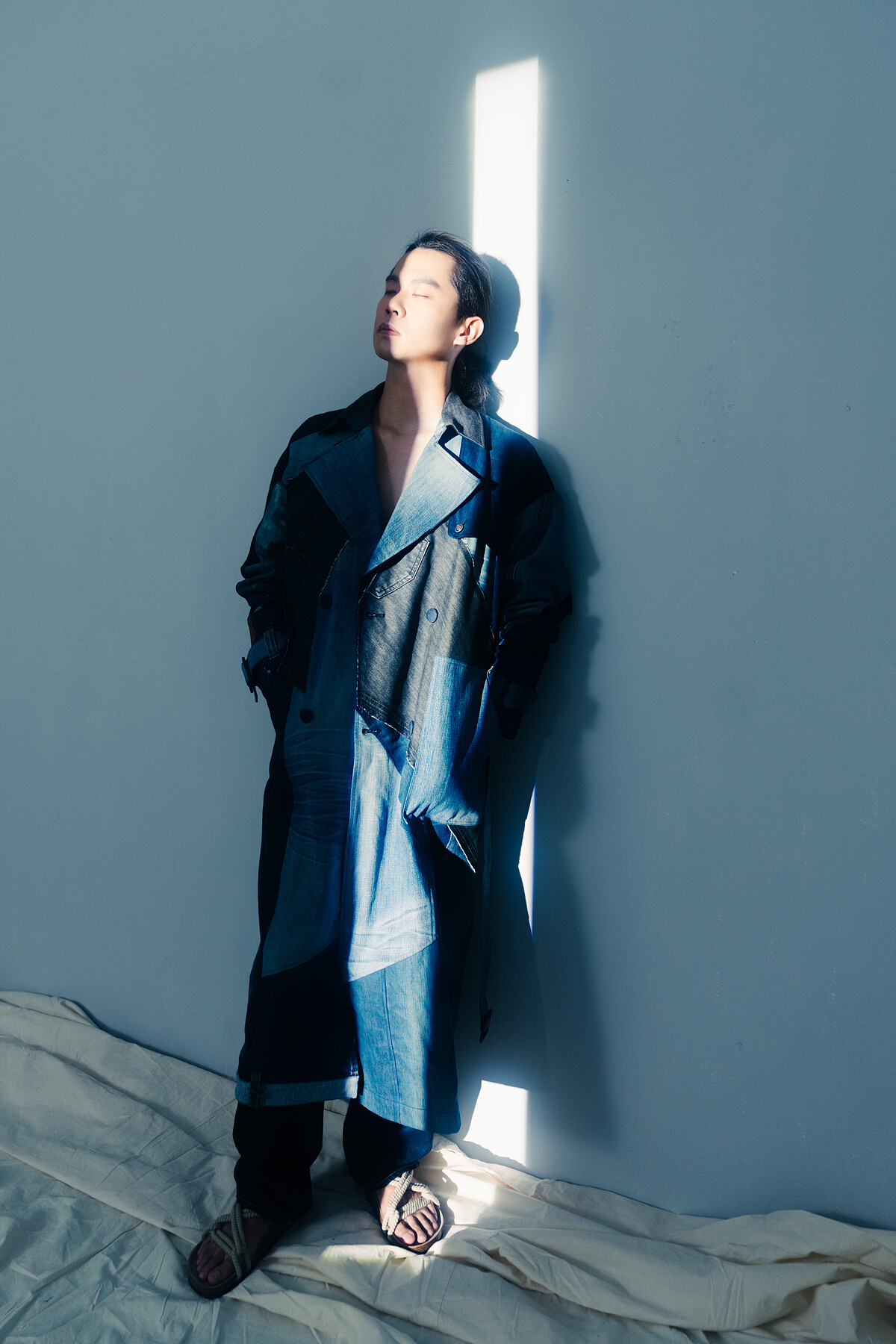 詹宗佑再製丹寧長版風衣並親自示範穿搭，運用開襟劍領、腰間綁帶等設計細節，讓牛仔面料翻玩出高街時尚的細緻感