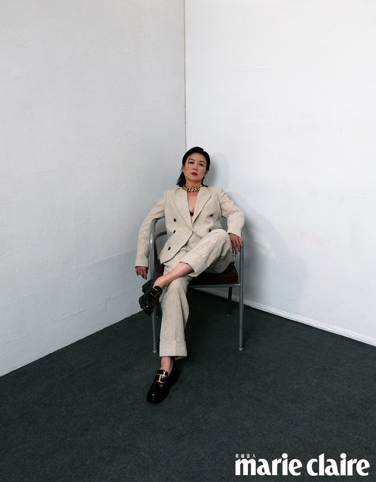 米色西裝外套、黑色內搭背心、米色西裝長褲，all by Brunello Cucinelli；黑色皮革樂福鞋，Tod&rsquo;s；金色項鍊，Recovery。