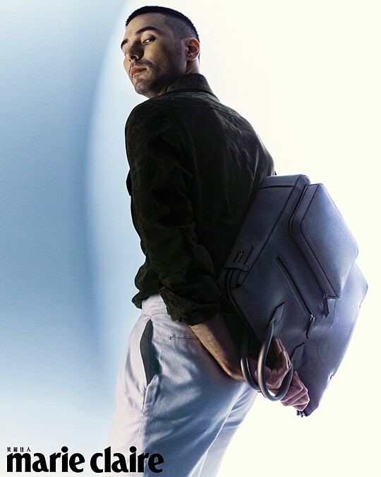 橘色針織 Polo 衫、咖啡色麂皮襯衫、白色長褲，all by Ralph Lauren； MONTBLANC大師傑作精選系列 Soft 手提袋，MONTBLANC。