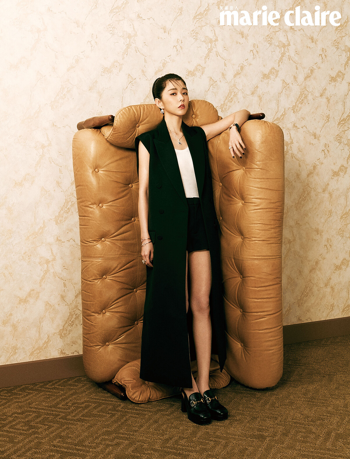 DIVAS’ DREAM 玫瑰金手工繪製孔雀珠寶腕錶、Divas’ Dream 白金鑽石藍寶項鍊、Divas’ Dream 白金鑽石藍寶耳環、Divas’ Dream 玫瑰金鑽石手環、Divas’ Dream 白金鑽石手環、Divas’ Dream 白金鑽石祖母綠戒指、Divas’ Dream 白金鑽石戒指,all by Bulgari;黑色無袖羊毛長背心、白色羊絨真絲背心、黑色低腰羊毛短褲、黑色女士馬銜扣高跟鞋,all by Gucci。