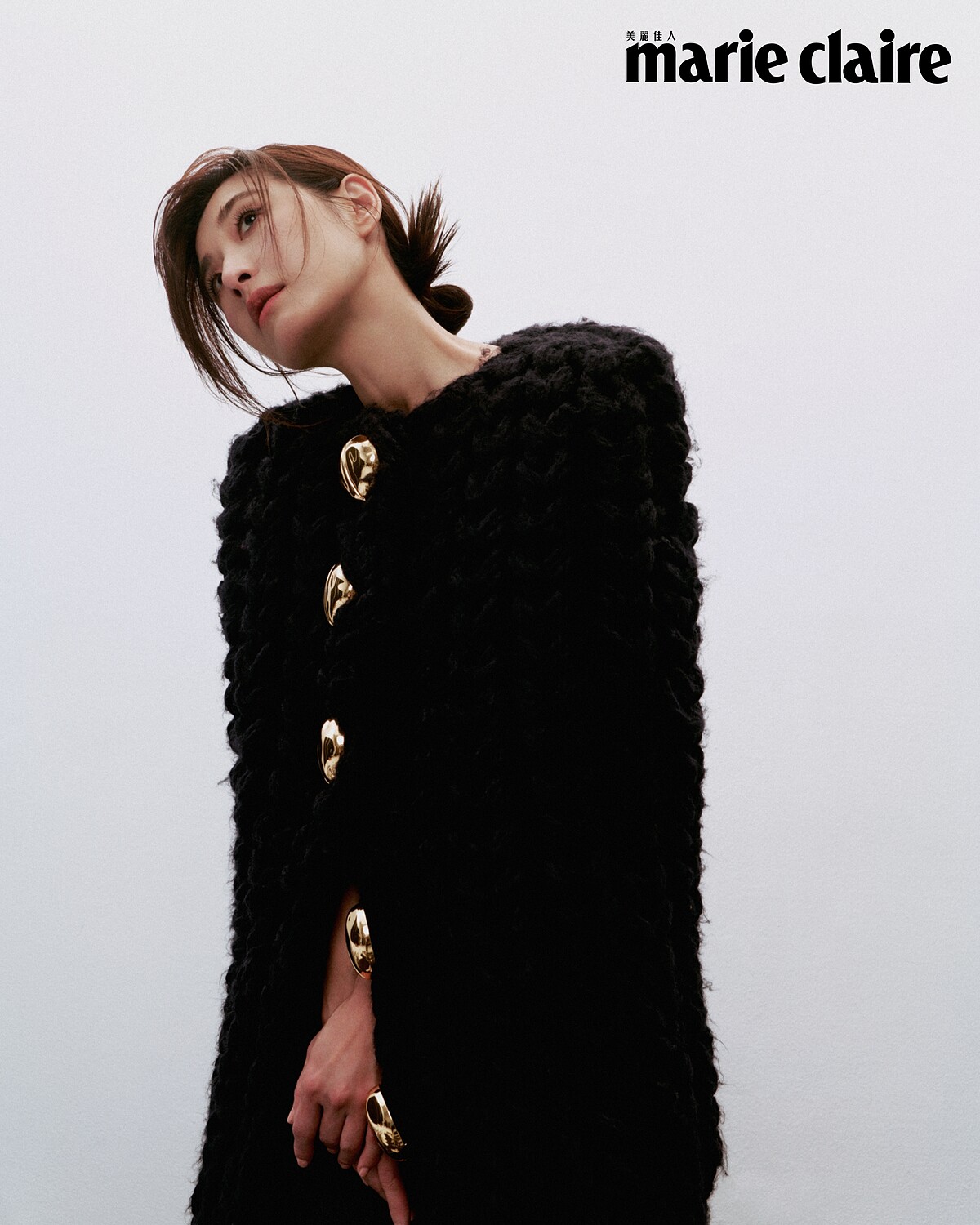 深藍色針織長罩衫，Loewe。