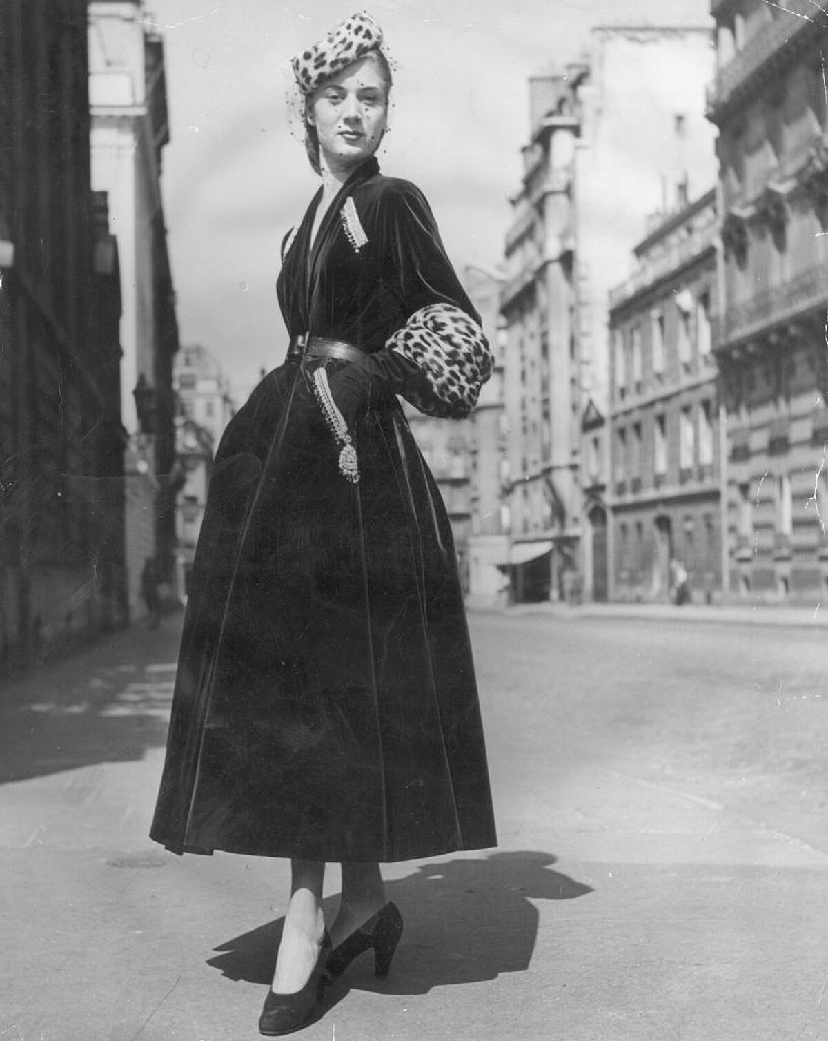 27th September 1947: 'Prince Igor', a Christian Dior design of full skirted green velvet coat with tight belt, gold and silver embroidery over slant pockets and deep leopard skin cuffs on three quarter length sleeves. A pillbox hat is also of leopard skin. (Photo by Savitry/Picture Post/Hulton Archive/Getty Images)