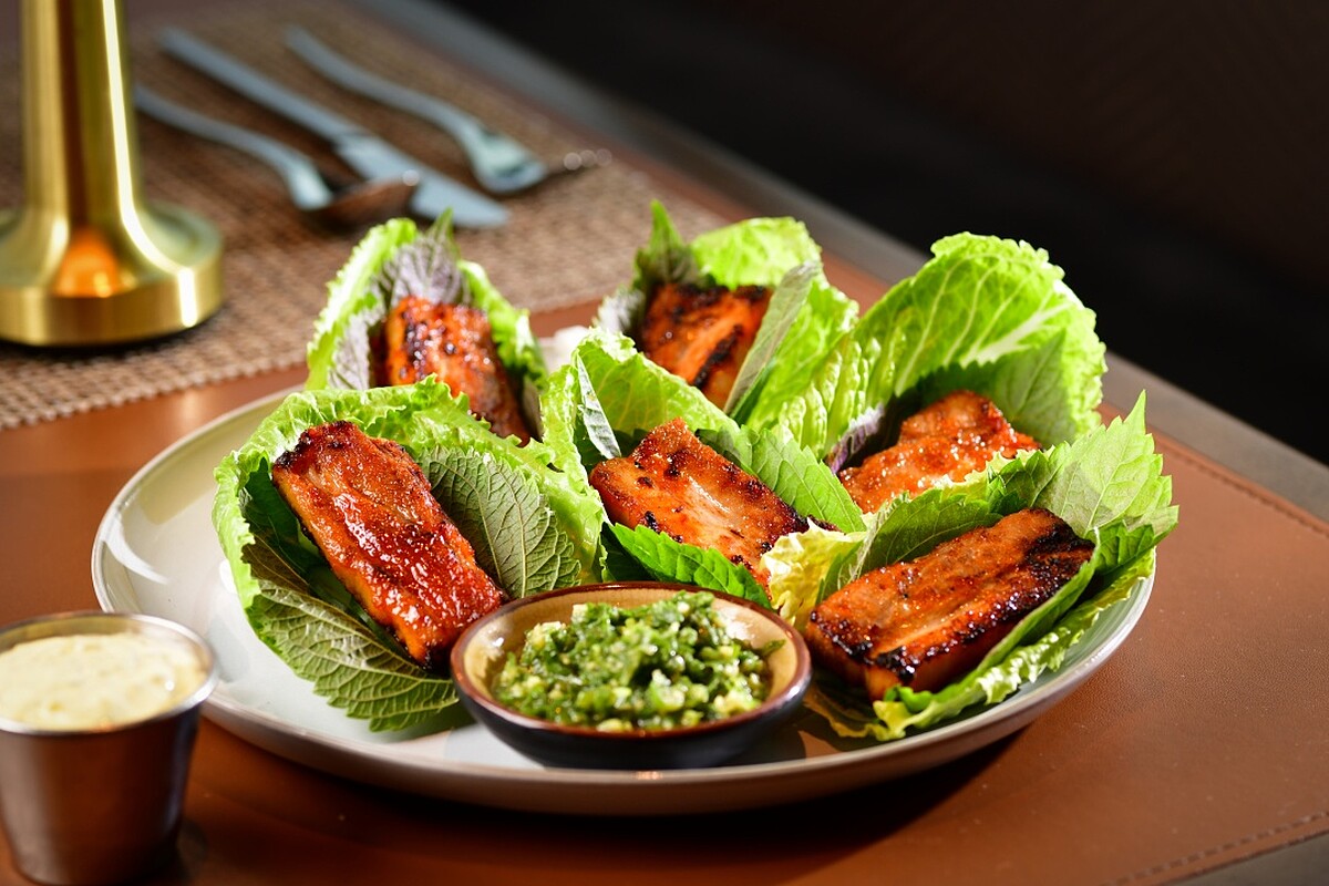 烤豬腹肉搭配生菜與芝麻葉。