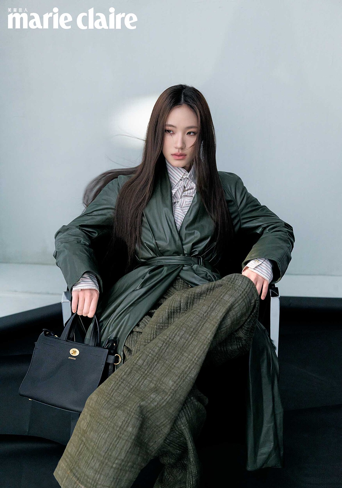 墨綠色皮大衣、條紋襯衫、棕色格紋長褲、黑色手提包，all by Burberry。