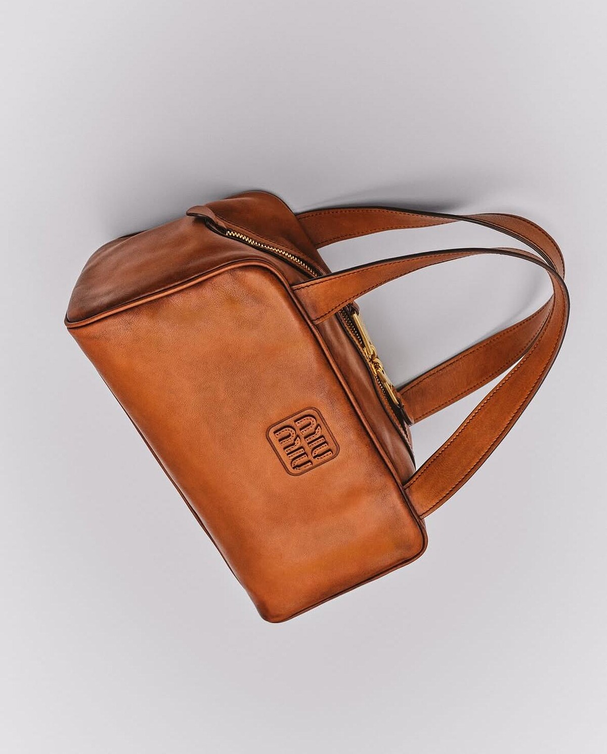 Miu Miu 干邑色皮革手袋，採用柔軟小牛皮與方正輪廓設計