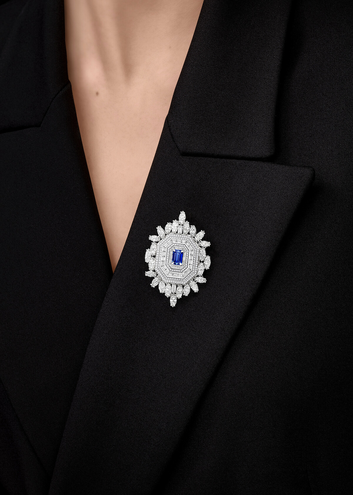 海瑞溫斯頓 Ultimate Emerald Signature頂級珠寶腕錶 / 胸針 這款腕錶鑲嵌鑽石和藍寶石，採用極簡底座，使寶石成為焦點，得以綻放無限璀璨光芒。長方形的錶面和八邊形的幾何造型呈獻出「鏡廳」的反射效果，具有極高的辨識度。除了佩戴於手腕，亦可以作為墜飾，並搭配鑲嵌12顆圓形明亮式切工鑽石的18K白金項鍊佩戴。另外，錶殼的背面飾有扣針，作為胸針點綴服裝，在紅毯等重要場合皆能展現迷人風采。