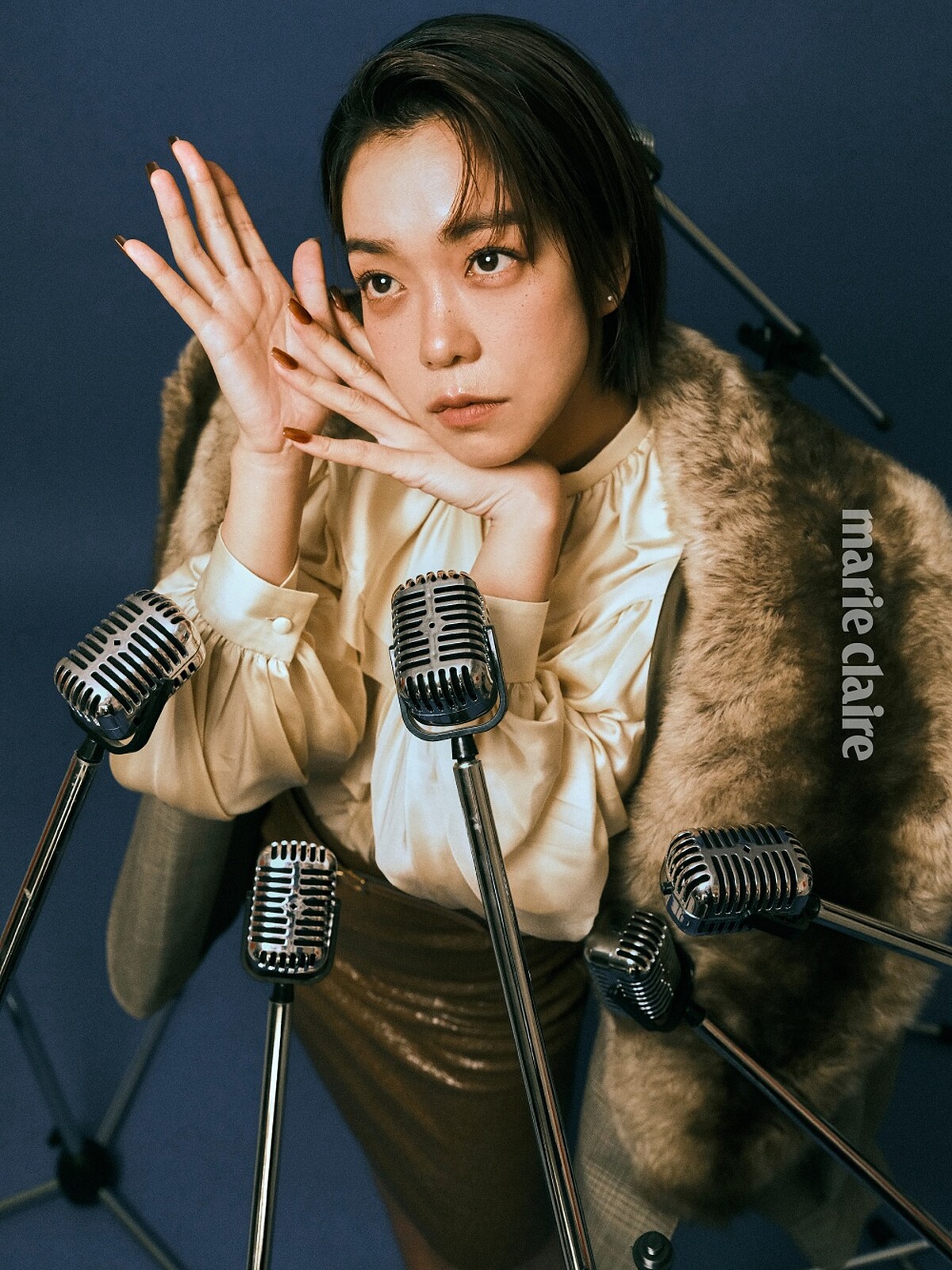 皮草領飾格紋夾克、米色飾褶襉滾邊絲質襯衫、焦糖色亮面皮革半身裙，All by Gucci。