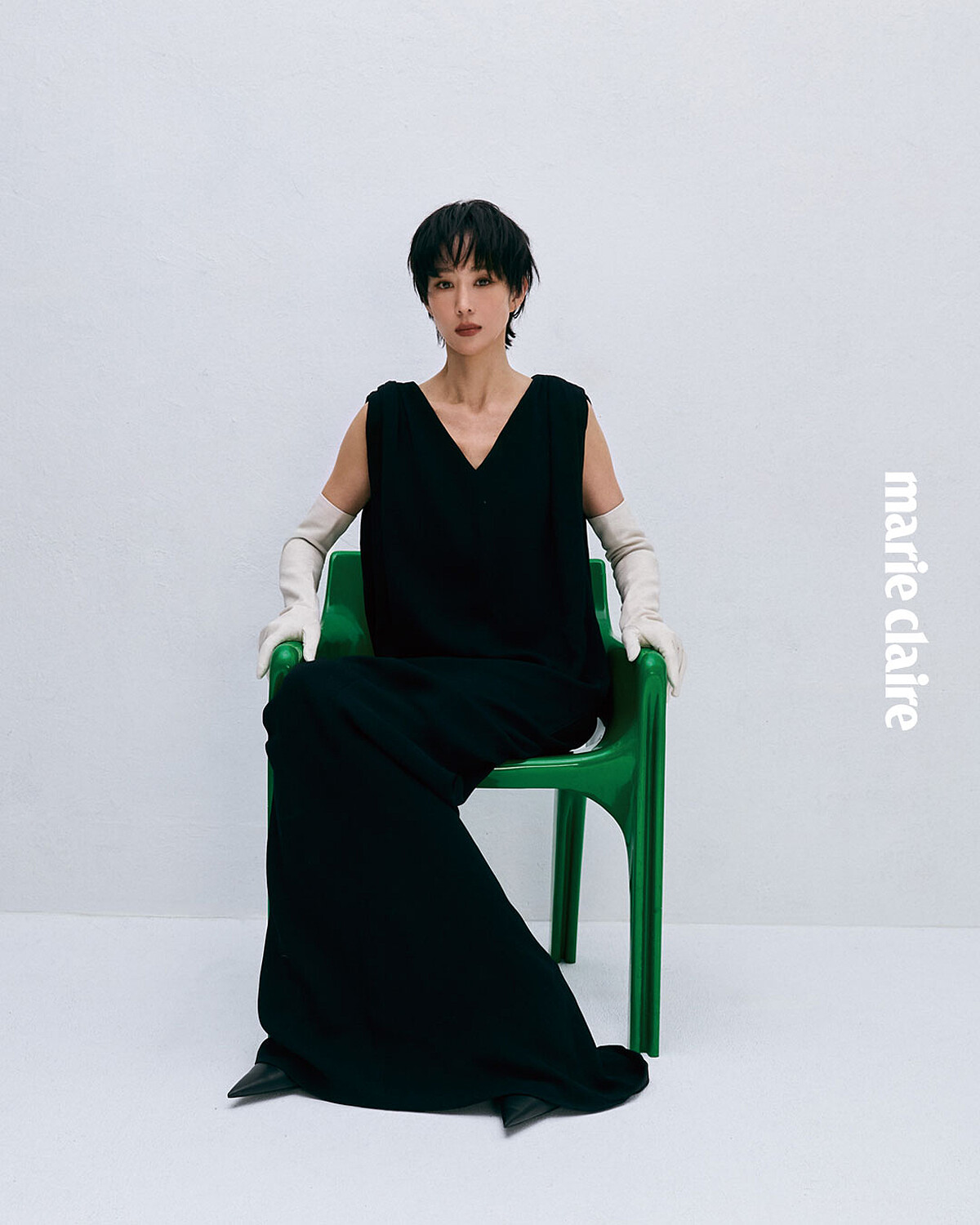 黑色造型禮服、白色皮革手套，both by Balenciaga。